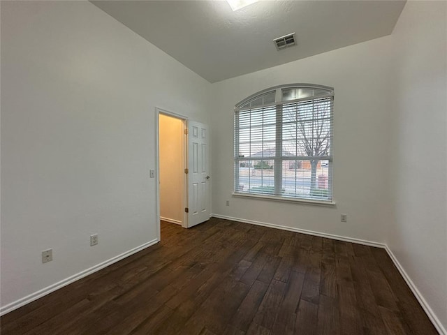 empty room with dark wood-type flooring