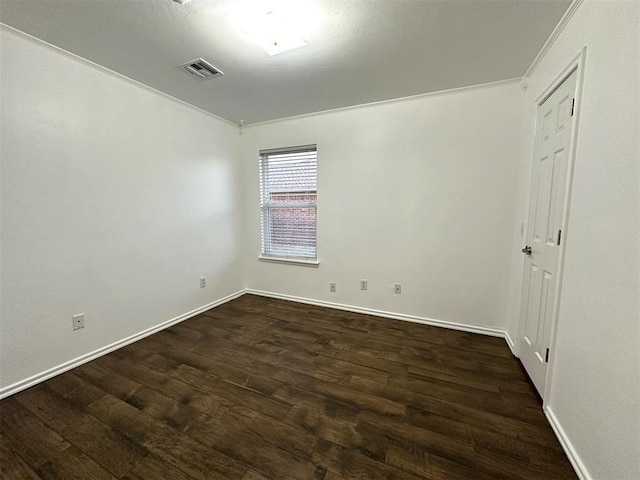 spare room with crown molding and dark hardwood / wood-style flooring