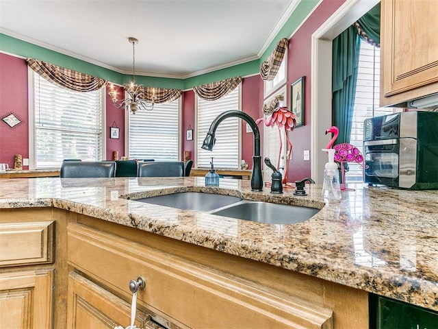 kitchen featuring crown molding, sink, hanging light fixtures, a notable chandelier, and light stone counters