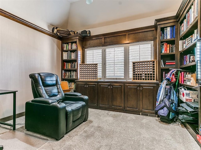 sitting room with lofted ceiling and light carpet