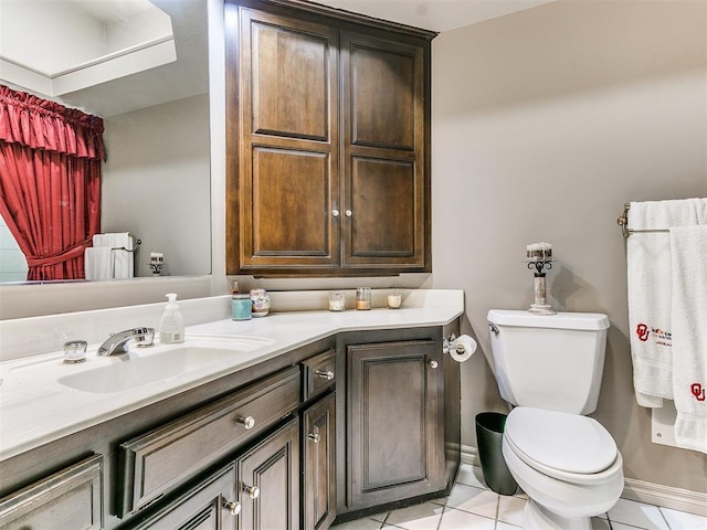 bathroom with tile patterned flooring, vanity, and toilet