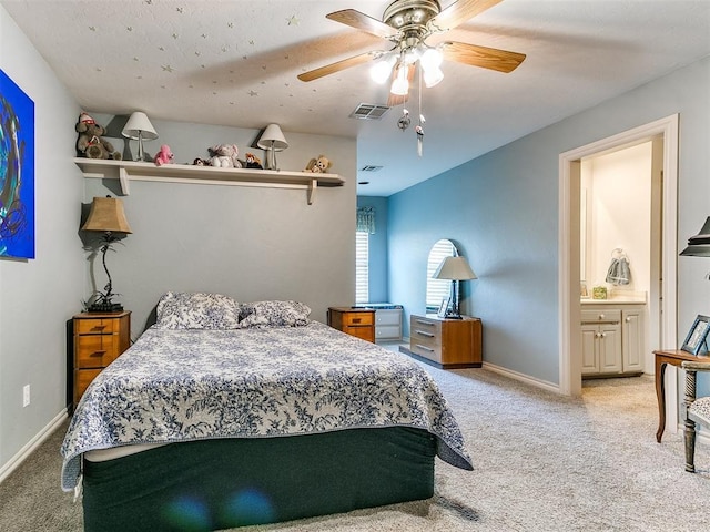 carpeted bedroom featuring ensuite bathroom and ceiling fan