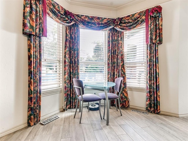 dining room featuring light wood-type flooring and ornamental molding