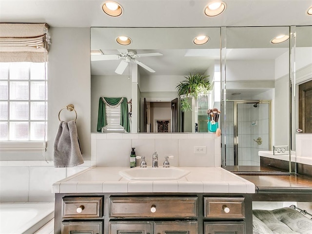 bathroom with backsplash, vanity, ceiling fan, and shower with separate bathtub