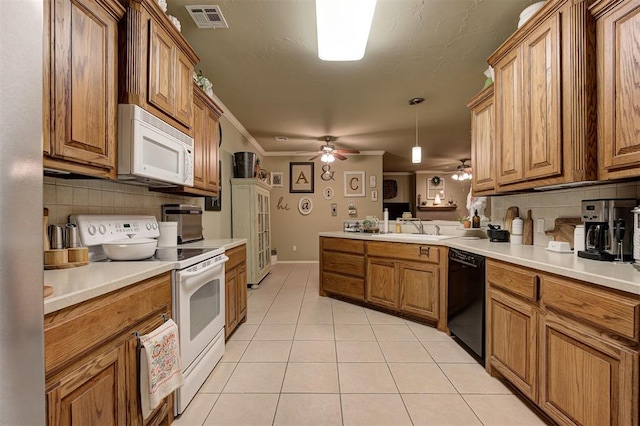 kitchen with backsplash, white appliances, crown molding, sink, and decorative light fixtures