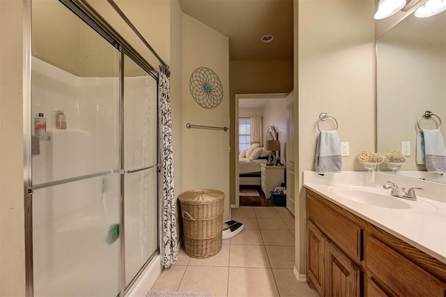 bathroom with vanity, tile patterned floors, and a shower with door