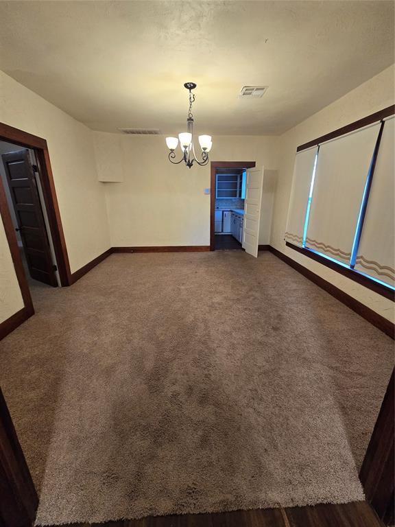 unfurnished dining area with a notable chandelier