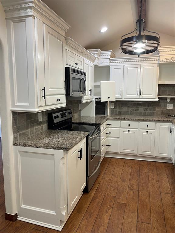 kitchen featuring hanging light fixtures, white cabinetry, appliances with stainless steel finishes, and dark wood finished floors