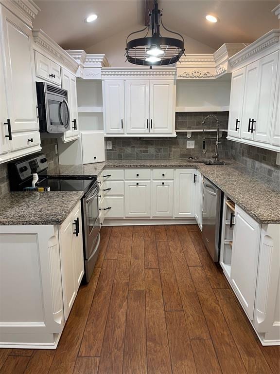 kitchen featuring pendant lighting, appliances with stainless steel finishes, a sink, and white cabinets