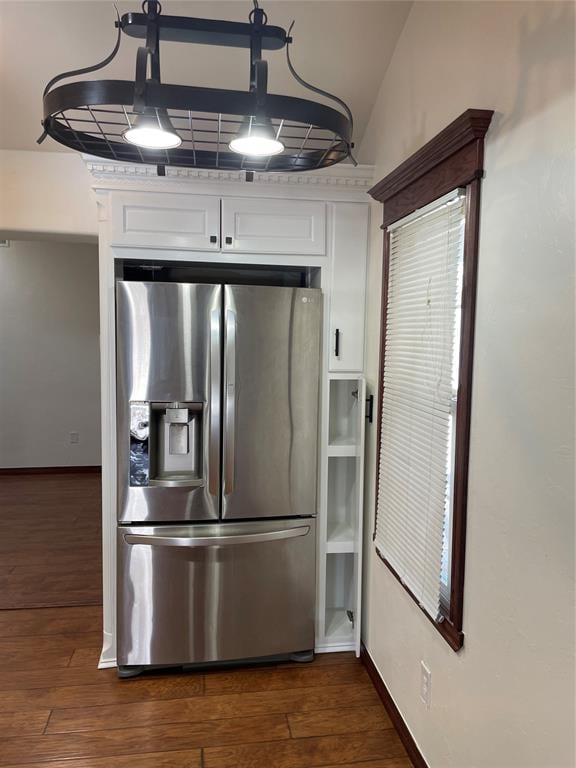 kitchen with light countertops, white cabinets, dark wood-type flooring, and stainless steel fridge with ice dispenser