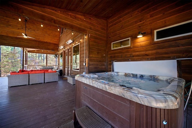 wooden deck with outdoor lounge area and a hot tub