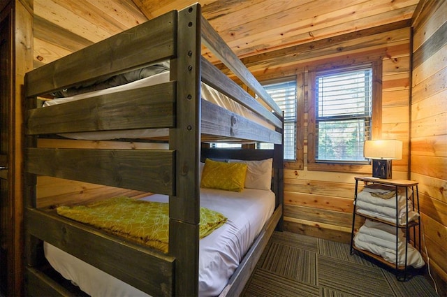 bedroom with wooden ceiling and wooden walls