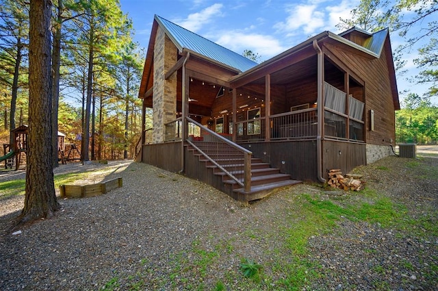 607 Sugar Pine Loop, Broken Bow, OK 74728 - rear view of property featuring cooling unit, metal roof, and stairway