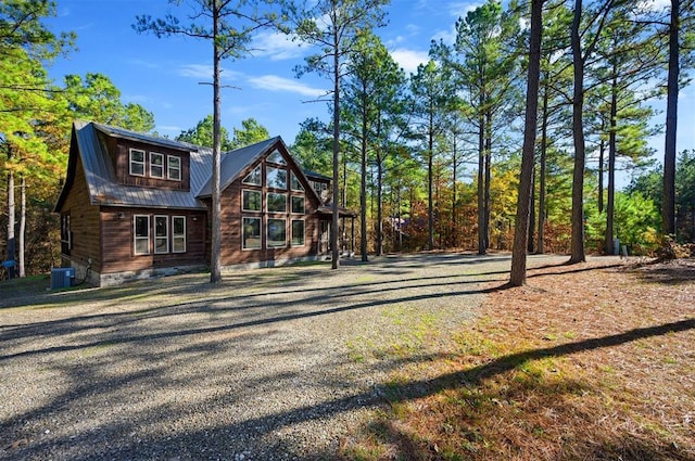 607 Sugar Pine Loop, Broken Bow, OK 74728 - rear view of property with cooling unit, metal roof, and gravel driveway