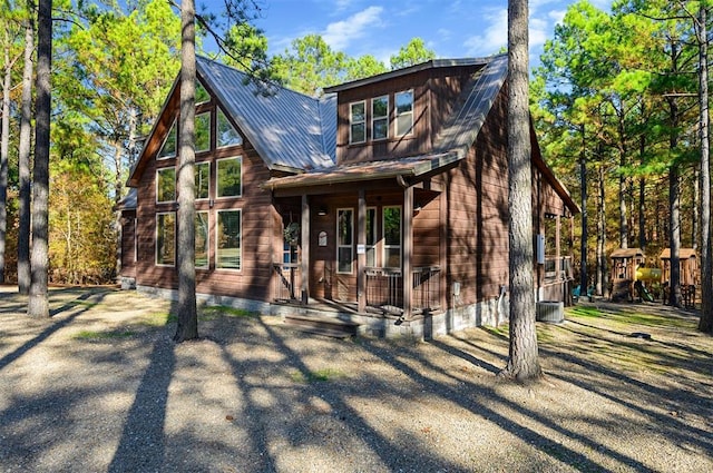 607 Sugar Pine Loop, Broken Bow, OK 74728 - view of front of property featuring a porch, metal roof, and a playground