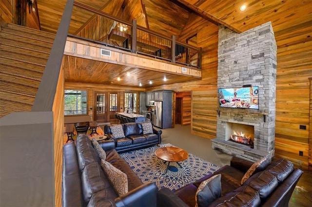 607 Sugar Pine Loop, Broken Bow, OK 74728 - living room featuring a high ceiling, wood ceiling, wood walls, a fireplace, and recessed lighting