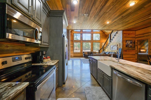 607 Sugar Pine Loop, Broken Bow, OK 74728 - kitchen featuring stainless steel appliances, wooden ceiling, wood walls, open floor plan, and a sink