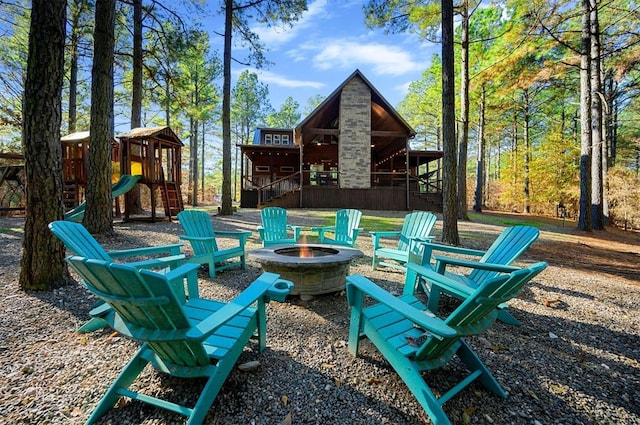 607 Sugar Pine Loop, Broken Bow, OK 74728 - view of patio featuring an outdoor fire pit, a deck, a playground, and stairs