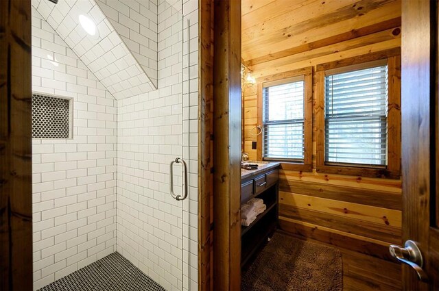 607 Sugar Pine Loop, Broken Bow, OK 74728 - bathroom featuring a shower stall, vanity, vaulted ceiling, and wooden walls