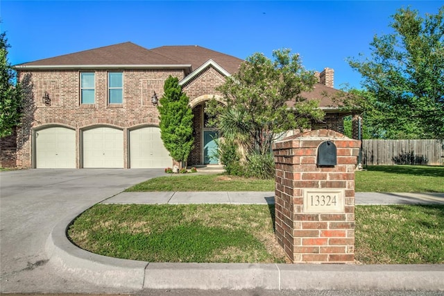 view of front property with a front yard and a garage