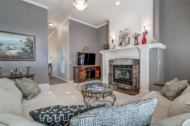 living room with a premium fireplace and ornamental molding