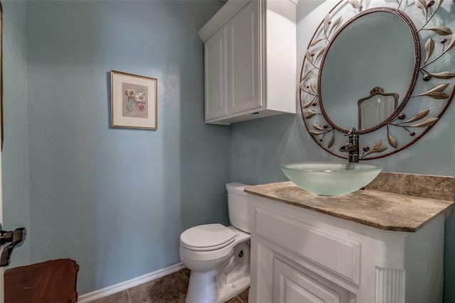 bathroom featuring tile patterned flooring, vanity, and toilet