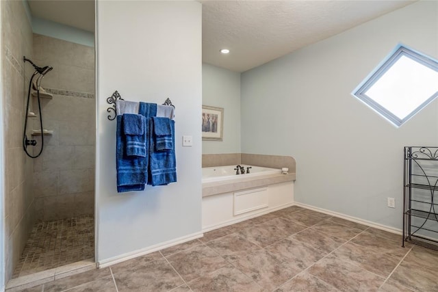 bathroom featuring separate shower and tub, tile patterned flooring, and a textured ceiling