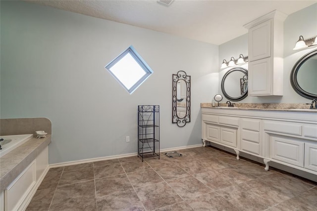 bathroom featuring tile patterned flooring and vanity