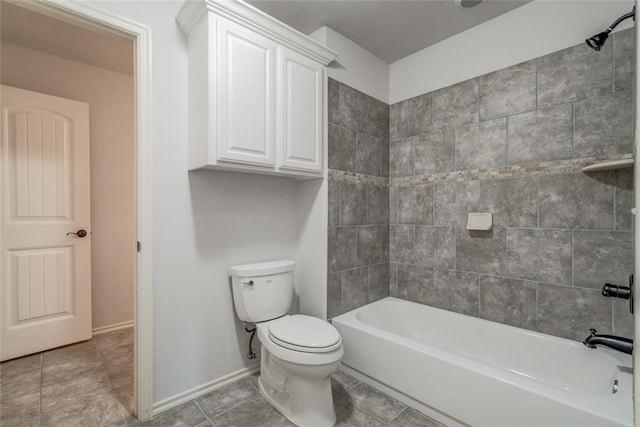 bathroom featuring tiled shower / bath combo and toilet