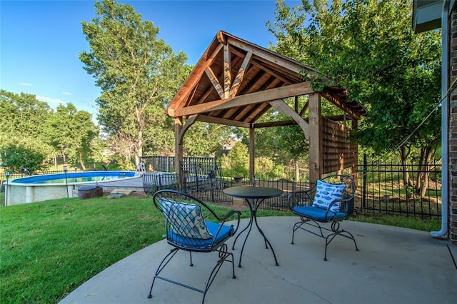 view of patio with a gazebo and a fenced in pool