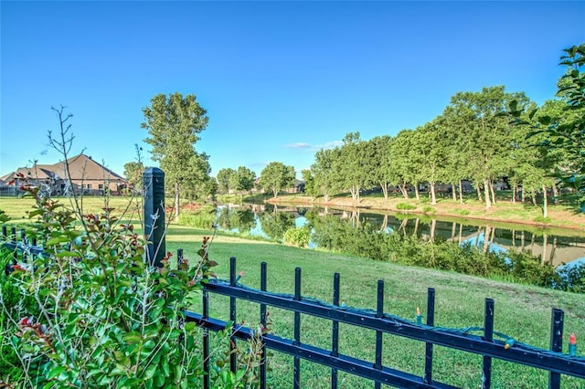 view of property's community featuring a water view and a lawn