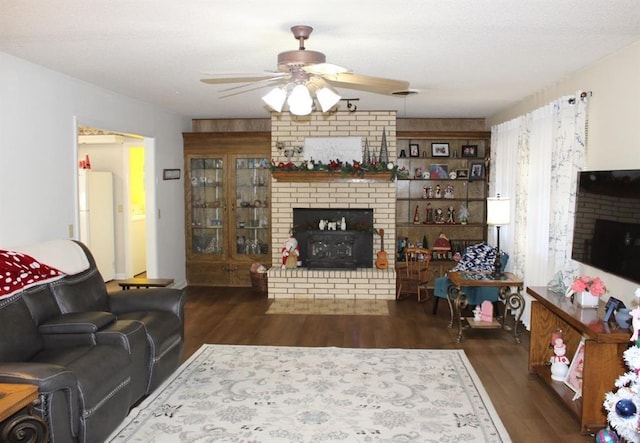 living room featuring ceiling fan, dark hardwood / wood-style flooring, and wooden walls