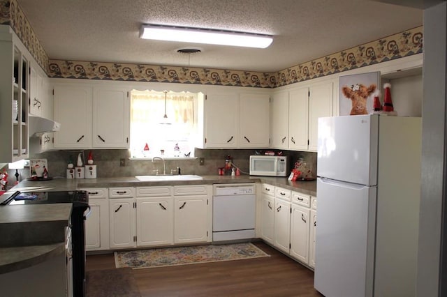 kitchen with decorative backsplash, dark hardwood / wood-style flooring, white appliances, sink, and white cabinets