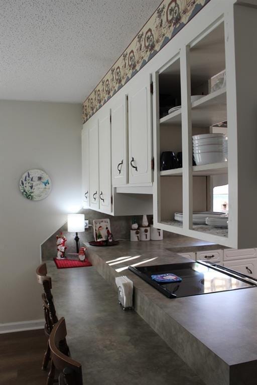 kitchen featuring white cabinetry and a textured ceiling