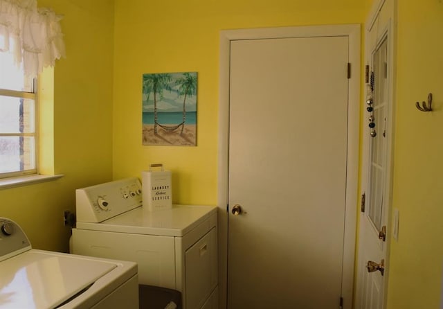 clothes washing area with washer and clothes dryer