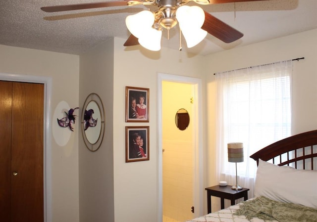 bedroom with a textured ceiling, a closet, and ceiling fan