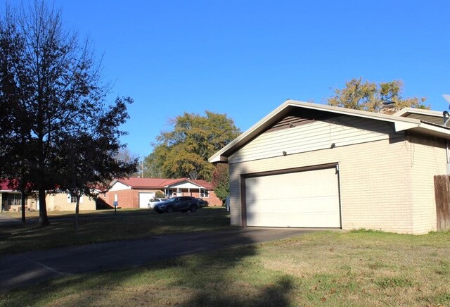 view of home's exterior with a yard and a garage