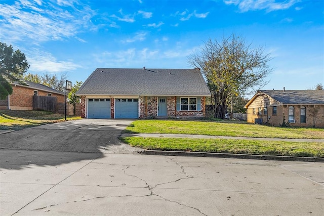 ranch-style home featuring a garage and a front lawn