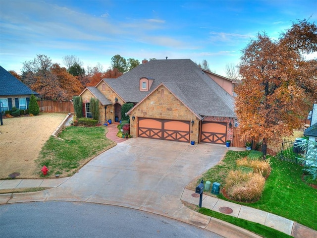 view of front of house with a garage and a front lawn