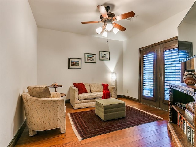 living room with hardwood / wood-style floors and ceiling fan