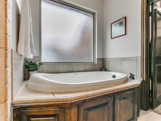 bathroom with a relaxing tiled tub