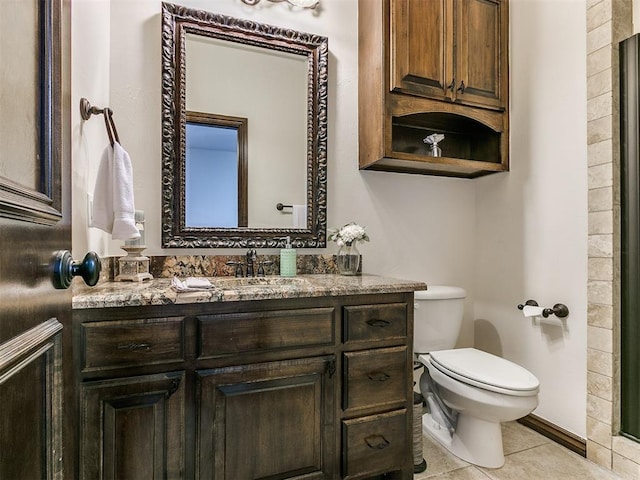 bathroom featuring vanity, tile patterned flooring, and toilet