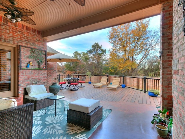 view of patio / terrace featuring a wooden deck, an outdoor hangout area, and ceiling fan