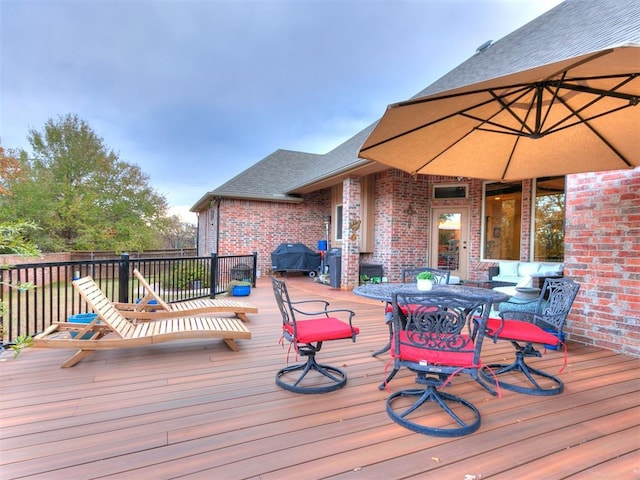 wooden terrace with a grill