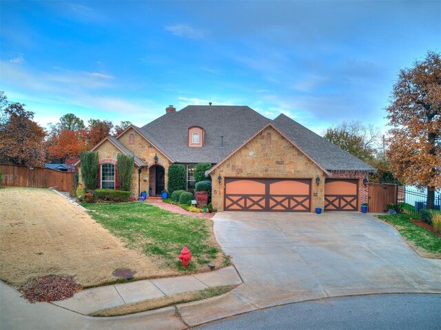 view of front of house featuring a garage and a front yard