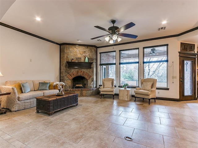 living room featuring ornamental molding, light tile patterned floors, ceiling fan, and a fireplace