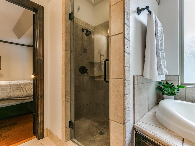 bathroom with tile patterned flooring and separate shower and tub