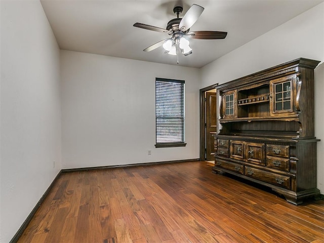 spare room featuring ceiling fan and dark hardwood / wood-style floors