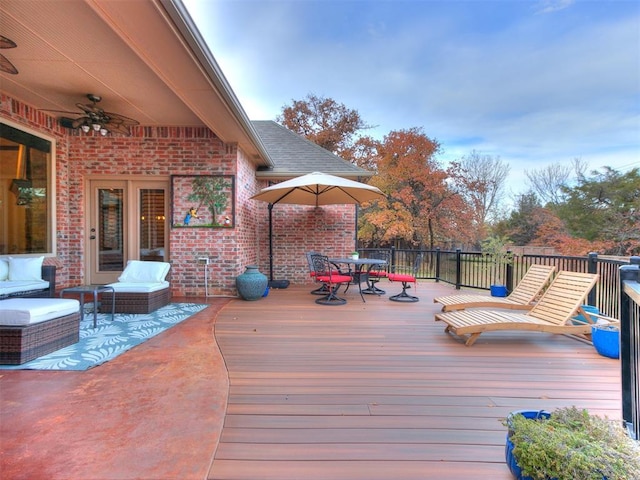 deck with an outdoor living space and ceiling fan