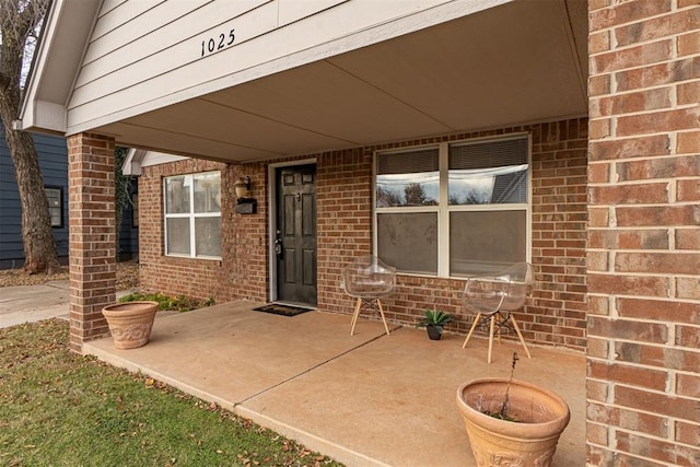 view of exterior entry featuring a patio